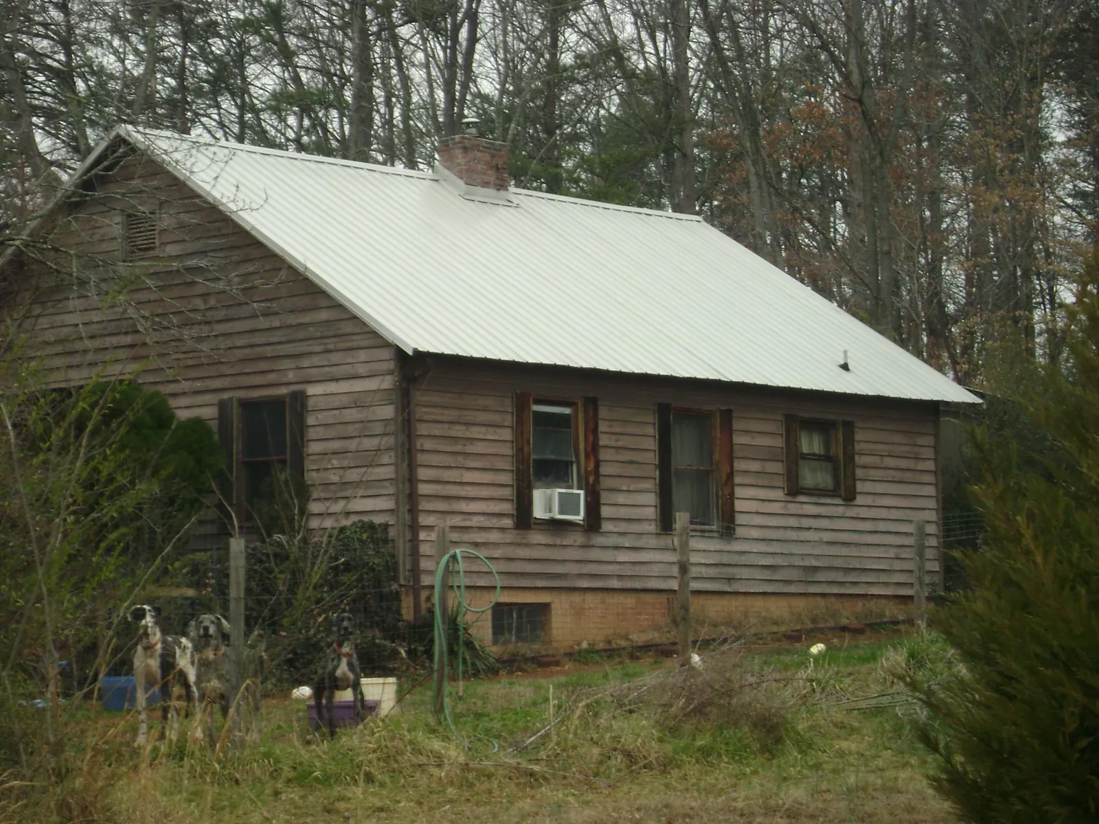 White metal roof on an old wood sided farmhouse, from a Metal Roof Installation job in Denmark